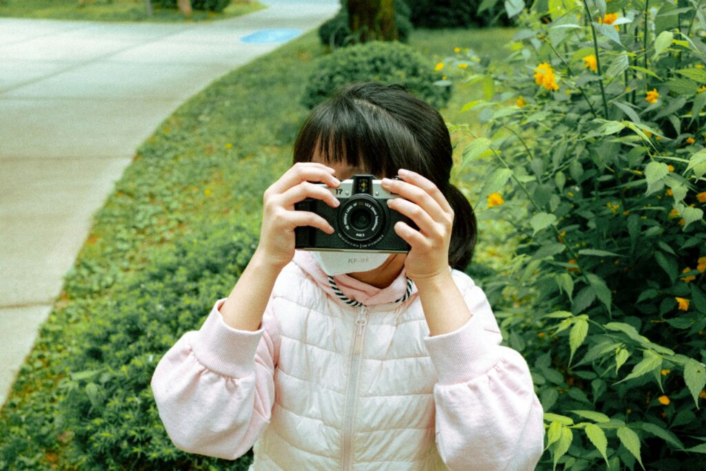 A girl takes a photo with her camera.