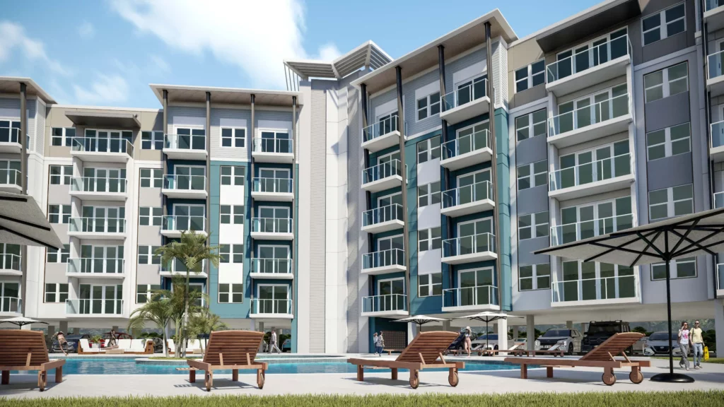 Exterior view of Champions Village pool area with lounge chairs and landscaped surroundings