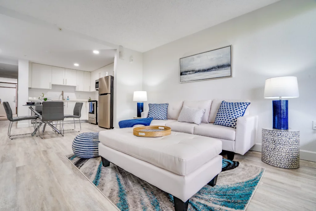 Alternate living room photo of Champions Village apartment with open-concept design and natural light