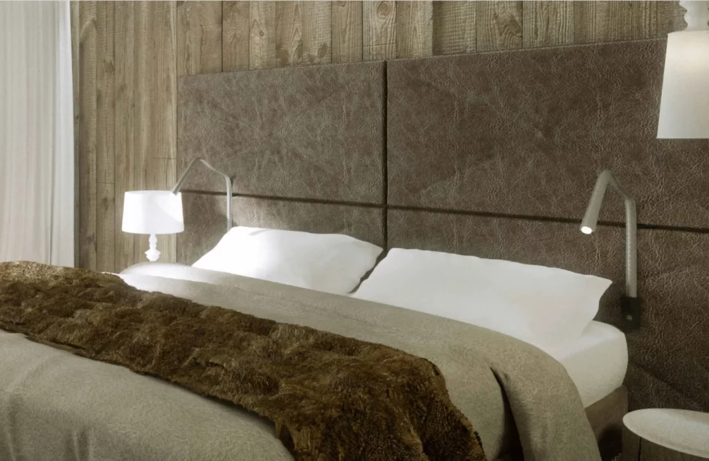 Guestroom at Ecrin Blanc with double bed and alpine-style interior