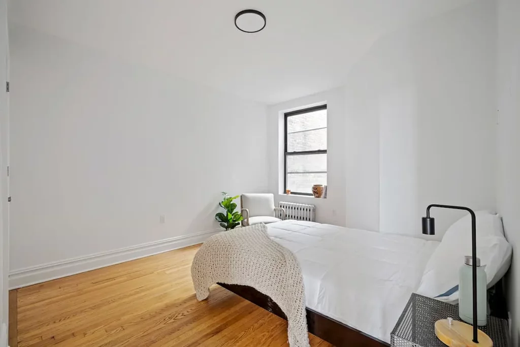 Bedroom at Greenpoint Avenue apartment featuring minimalist decor and natural light